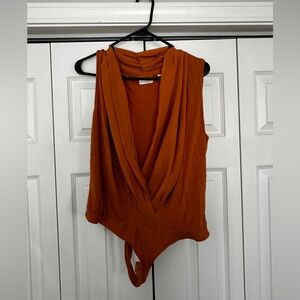 Eva Mendes burnt orange body suit.